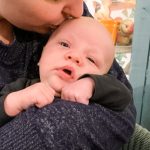 motherhood kissing baby