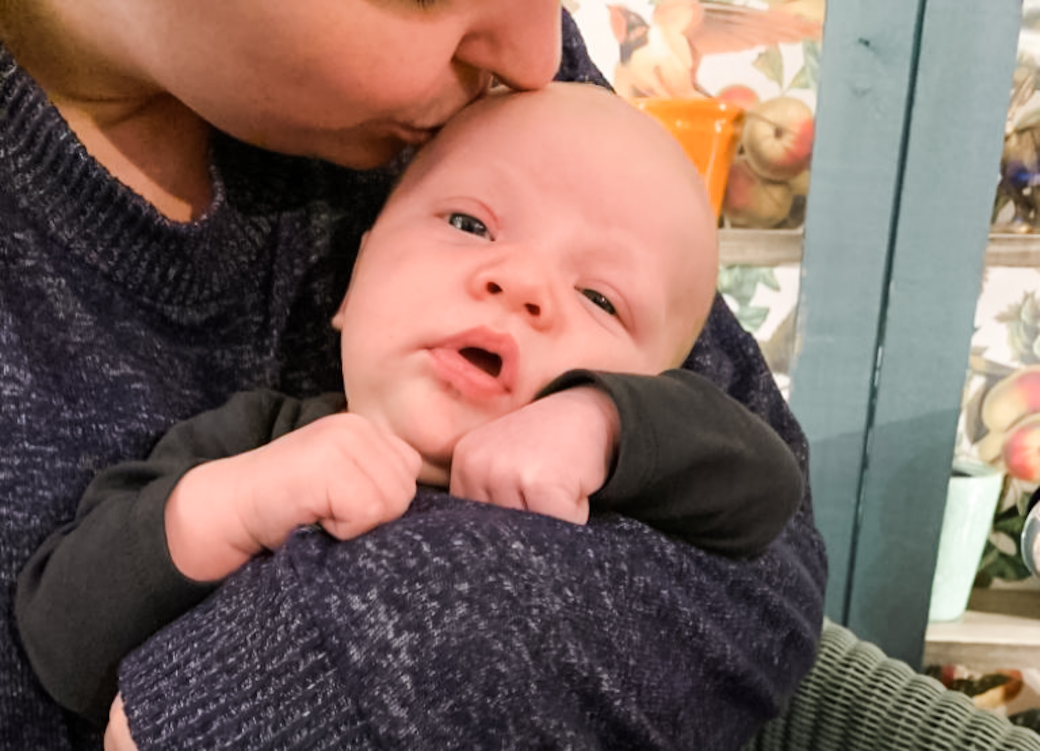 motherhood kissing baby